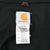 Close-up of Carhartt interior label showing style J25 DKB and Medium Regular sizing