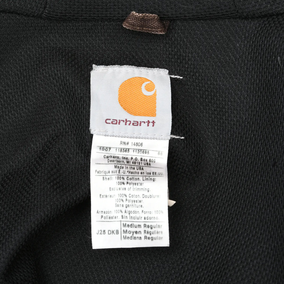 Close-up of Carhartt interior label showing style J25 DKB and Medium Regular sizing