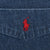 Close-up of red Polo Ralph Lauren pony embroidery on dark blue denim chest pocket