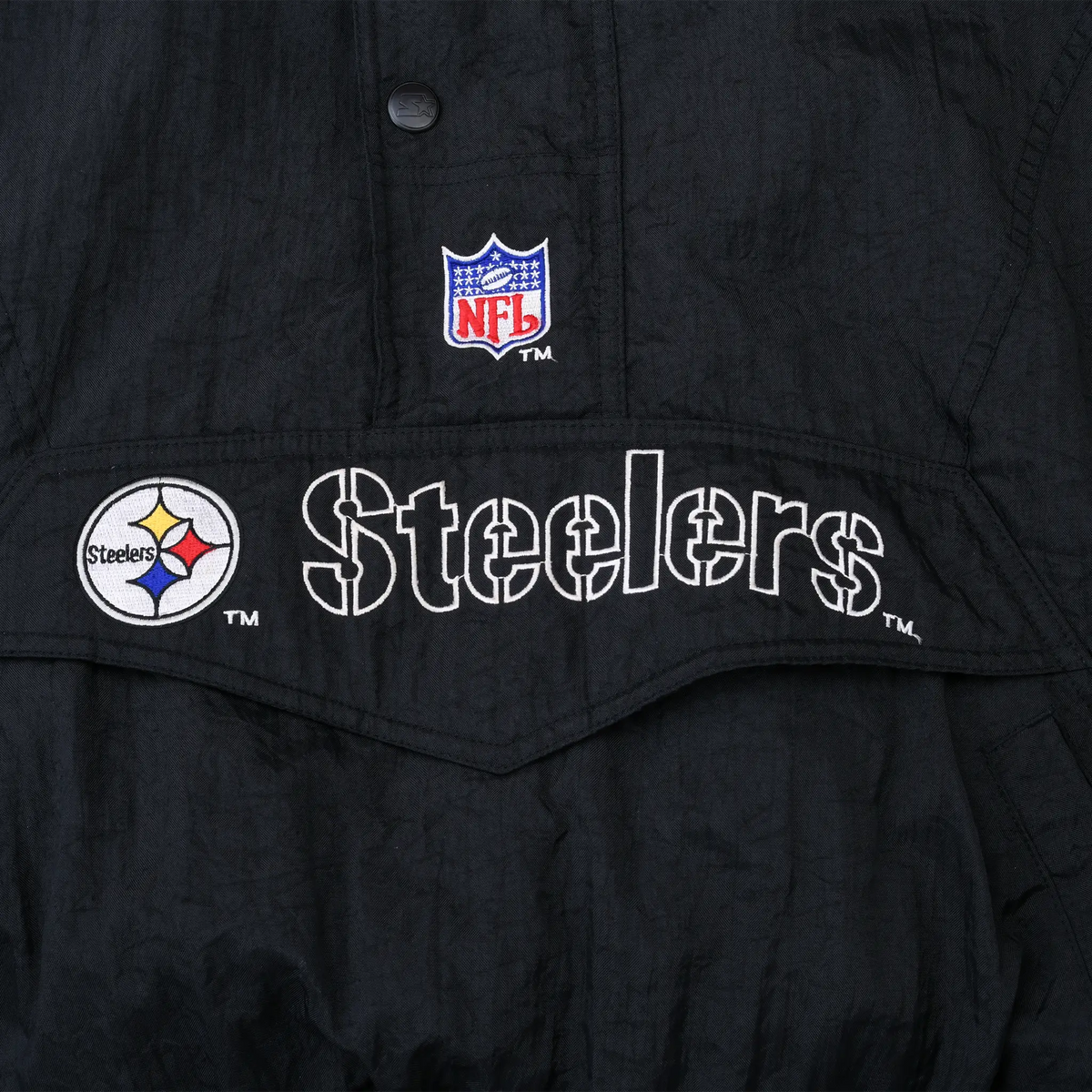 Close-up of embroidered NFL shield, Steelers name, and team logo on front pocket flap