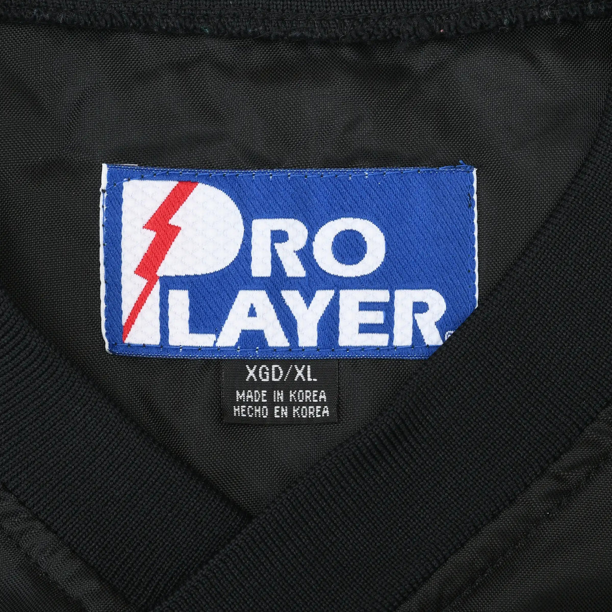 Close-up of blue Pro Player neck label with XGO/XL size marking
