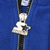 Close-up of silver Starter logo zipper pull on blue fleece