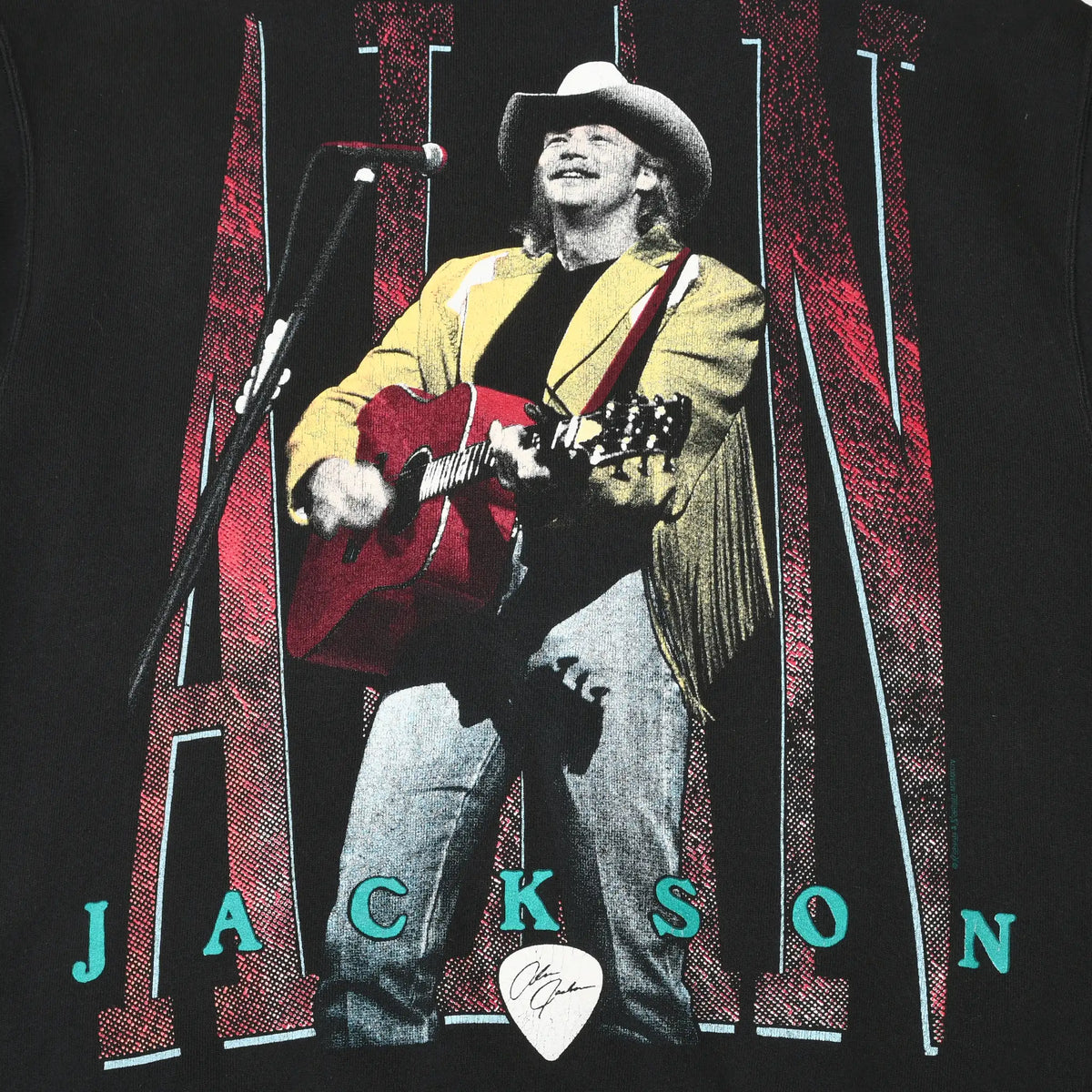 Close-up of front Alan Jackson graphic showing him singing and playing a red guitar