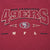 Close-up of embroidered San Francisco 49ers chest lettering, team logo, and NFL initials