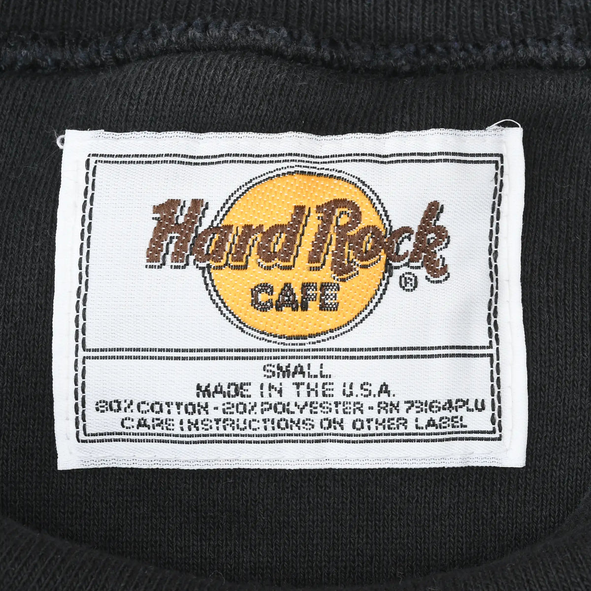 Close-up of Hard Rock Cafe neck label marked Small and Made in the U.S.A.
