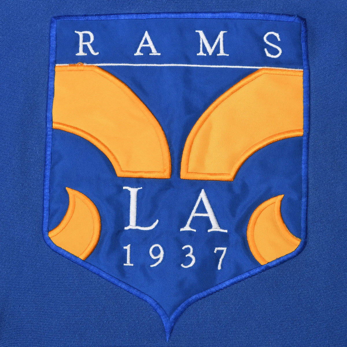 Close-up of blue and gold Rams LA 1937 crest on the hoodie chest