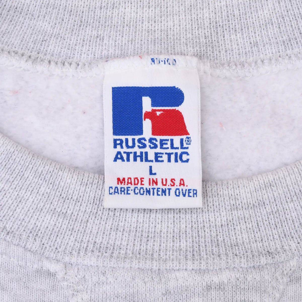 Close-up of Russell Athletic size L neck label inside gray sweatshirt