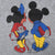 Close-up of back print showing Mickey and Minnie Mouse from behind with books