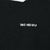 Close-up of 1993 NFLP trademark text printed on black fabric