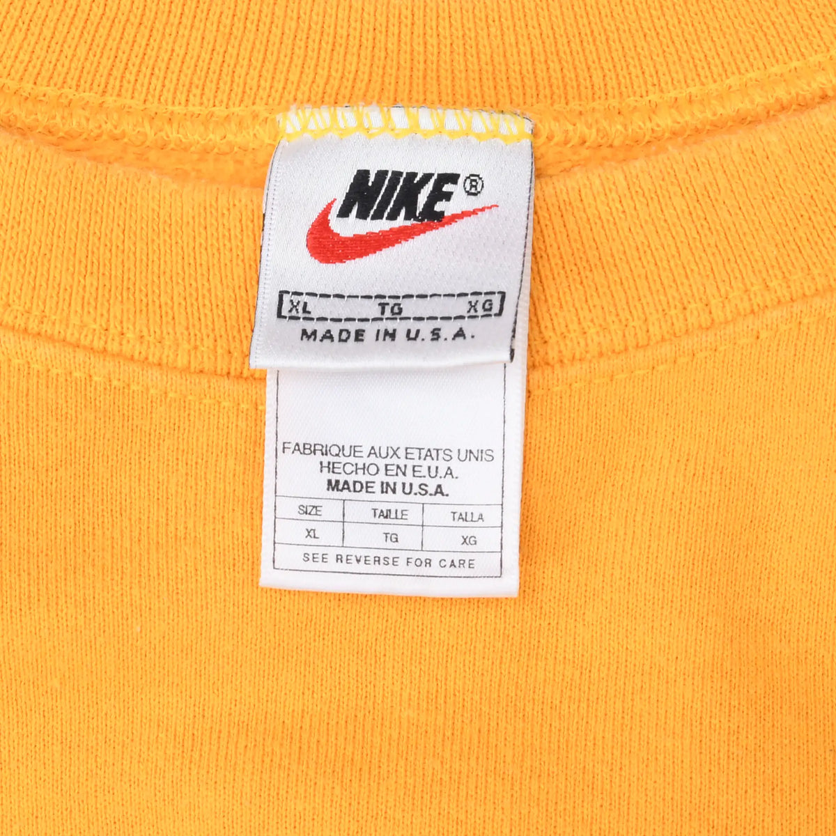 Nike neck and care labels marked XL and Made in U.S.A. inside yellow sweatshirt