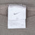 Nike neck tag showing Swoosh logo and XXL size inside khaki sweatshirt