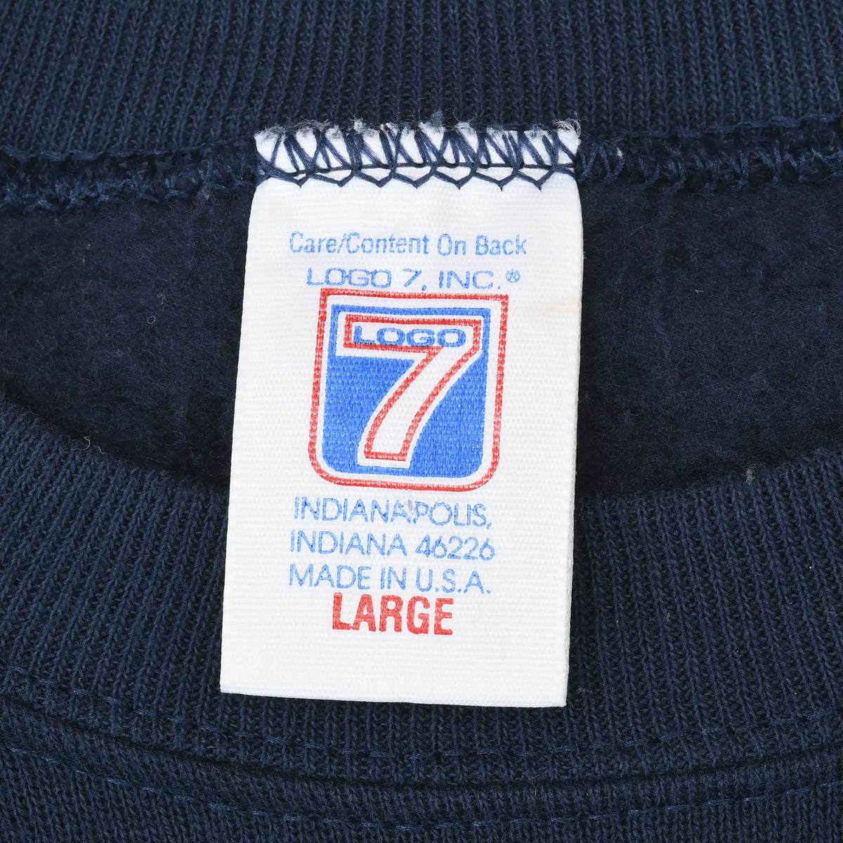 Logo 7 neck label marked large and made in USA inside navy sweatshirt
