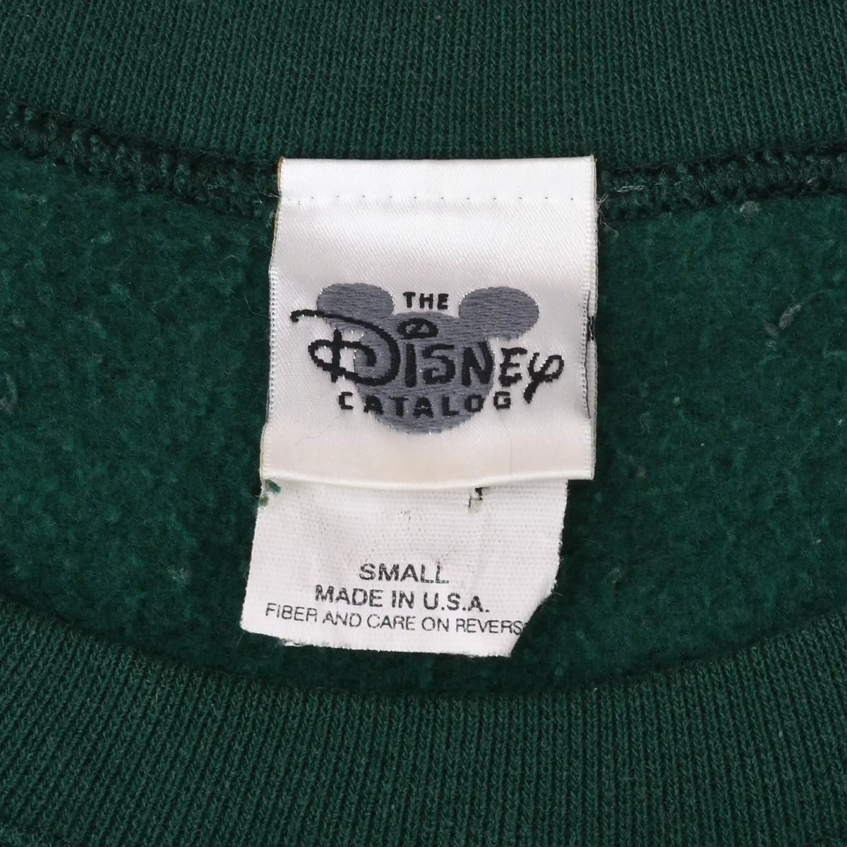 Close-up of The Disney Catalog neck tag marked small and Made in U.S.A.
