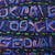 Close-up of black fabric with purple, blue and orange abstract shapes and small green geckos