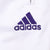 Close-up of purple Adidas logo embroidery on white track pants