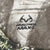 Close-up of Realtree Max-1 antler logo printed on camouflage fabric