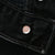 Close-up of metal button stamped 653 on black Levi's jeans