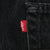 Close-up of red Levi's tab beside a back pocket on black denim