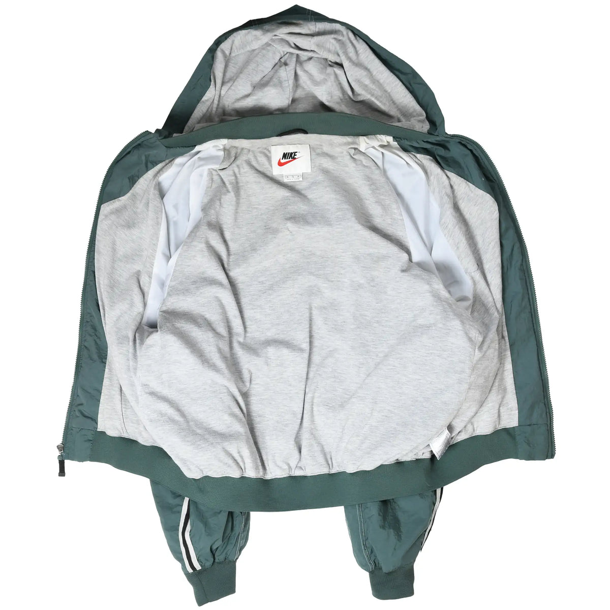 Open green Nike windbreaker showing gray interior lining and neck label