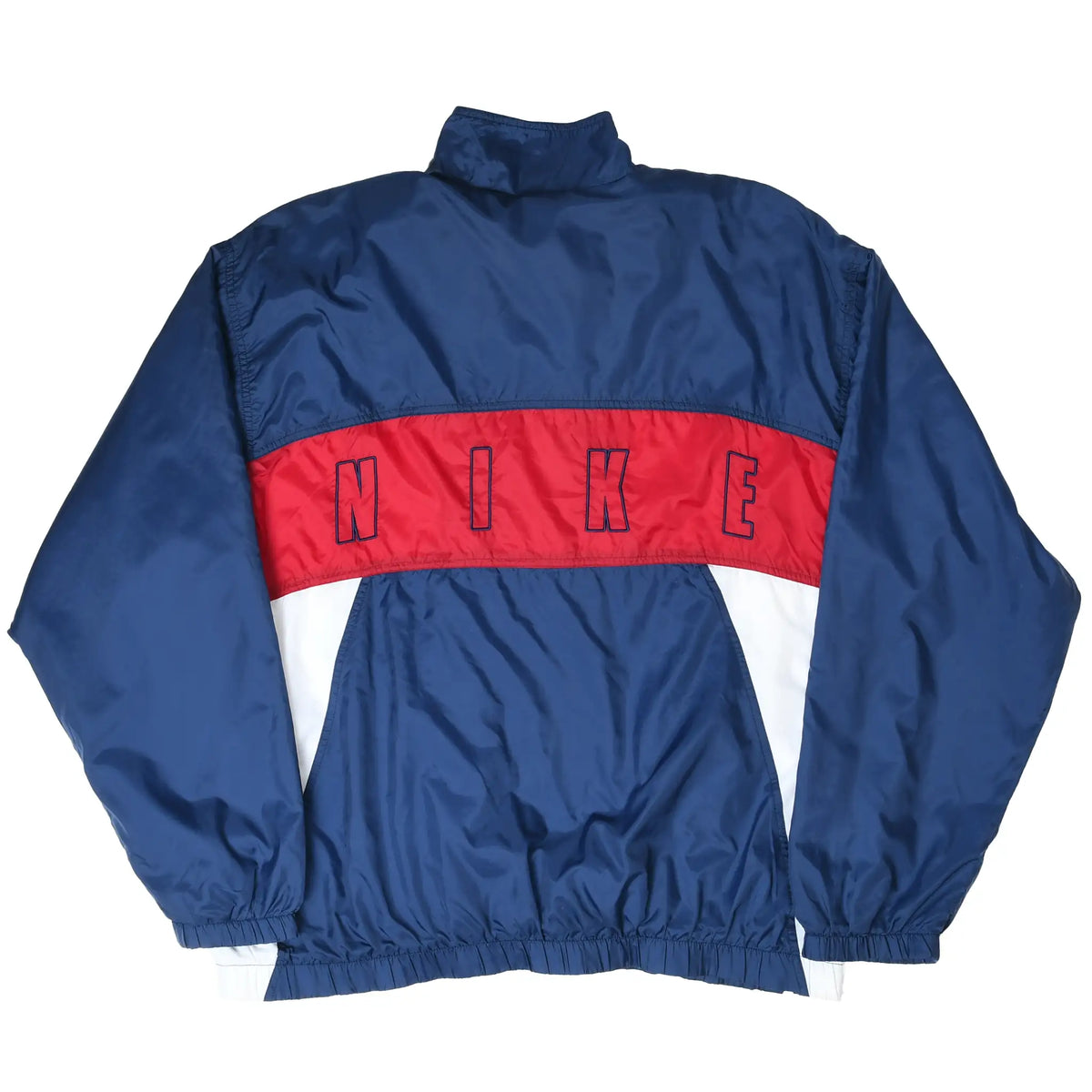 Back of navy Nike windbreaker jacket with outlined NIKE lettering across a red stripe and white panels
