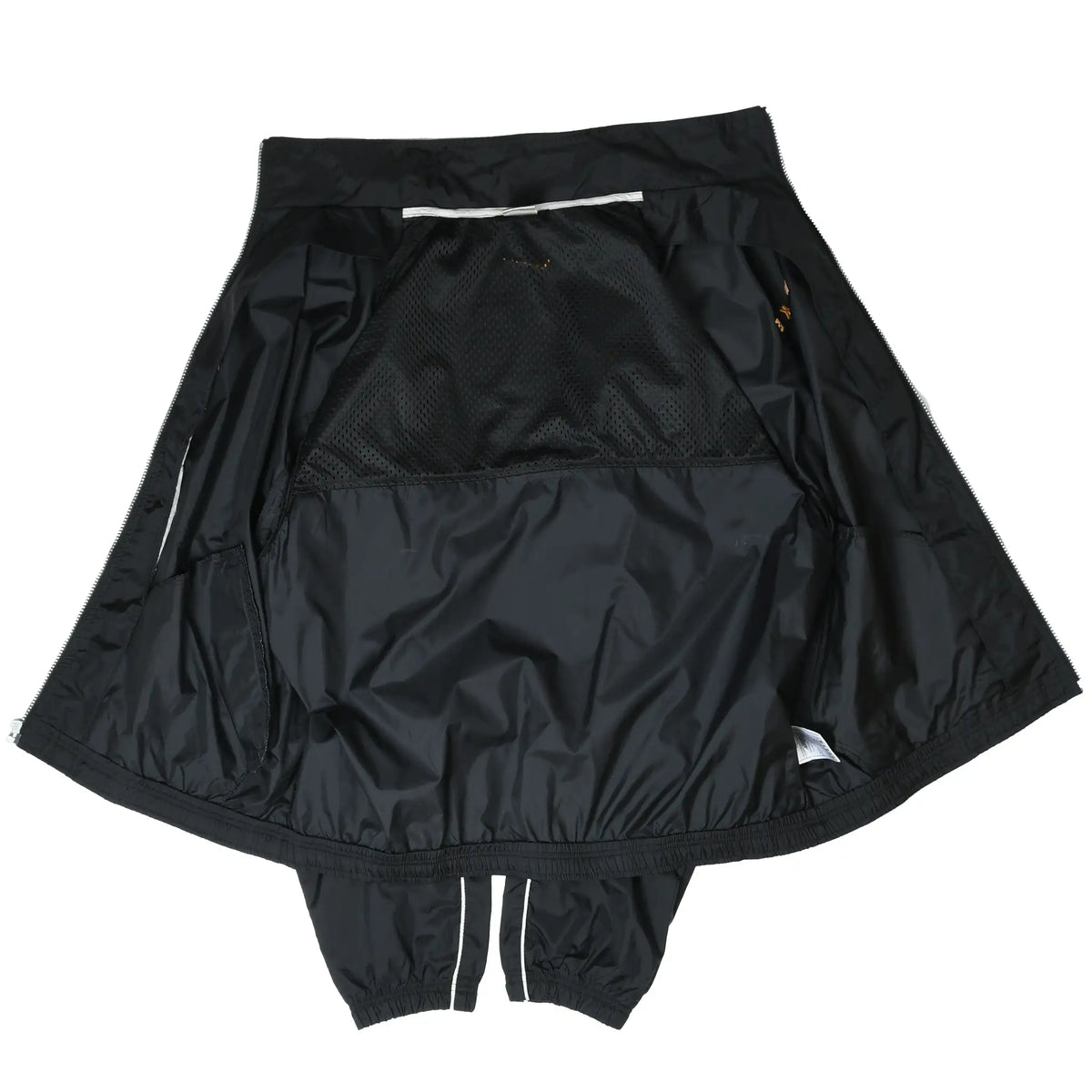 Interior view of open black Nike windbreaker showing mesh lining and inner construction