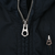 Close-up of silver Polo-branded zipper pulls on black Ralph Lauren jacket