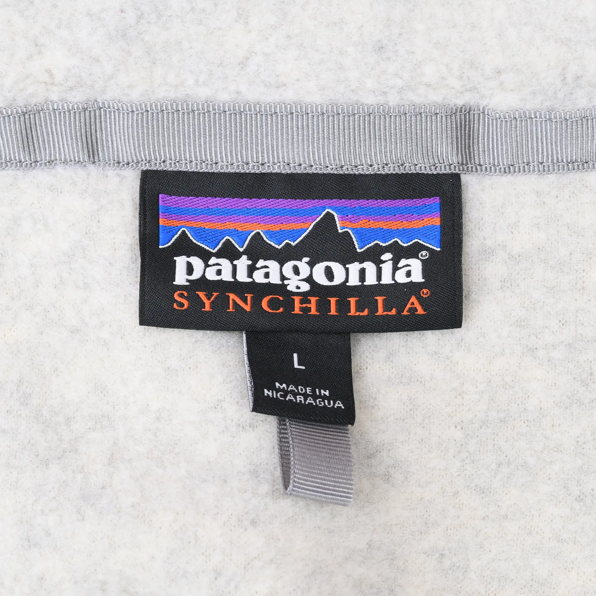 Close-up of Patagonia Synchilla neck label and size L tag