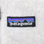 Close-up of Patagonia mountain logo patch on beige fleece