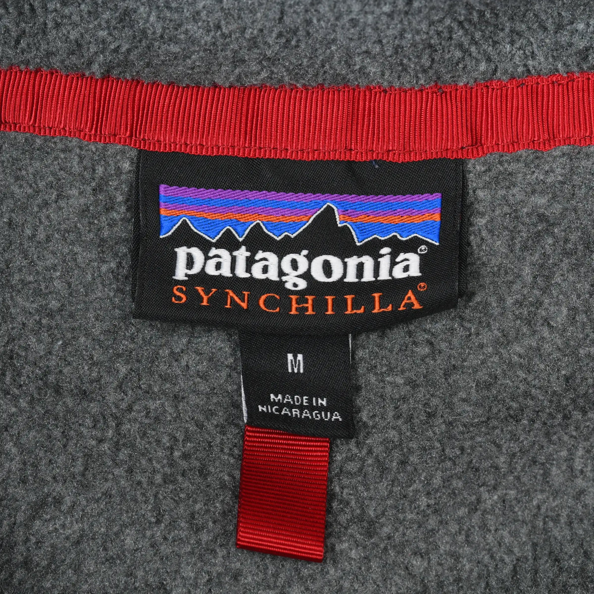Patagonia Synchilla neck label with medium size tag and red collar trim