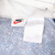 Nike neck label and care tag inside blue patterned hooded jacket