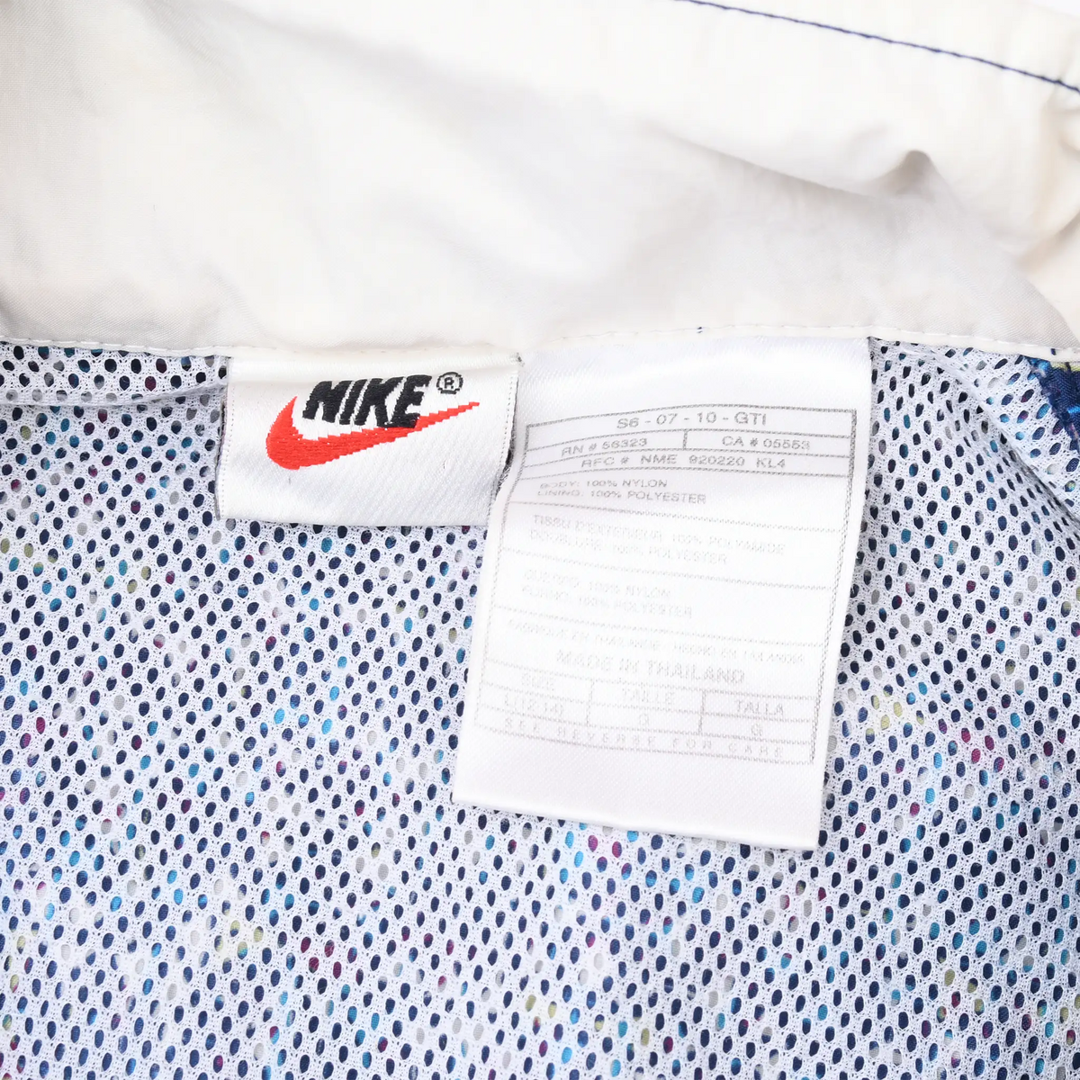 Nike neck label and care tag inside blue patterned hooded jacket