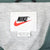 Nike neck label with black logo, red Swoosh, XL sizing, and Made in Taiwan text