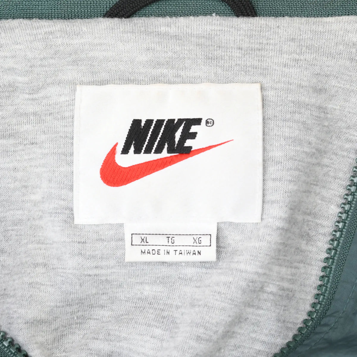 Nike neck label with black logo, red Swoosh, XL sizing, and Made in Taiwan text