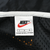 Nike neck label marked size L inside black mesh-lined windbreaker