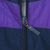 Close-up of Adidas-branded zipper pull on the purple and navy windbreaker