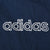 Close-up of white Adidas wordmark embroidery on navy fabric