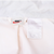 Interior Nike brand and care labels inside the white windbreaker lining
