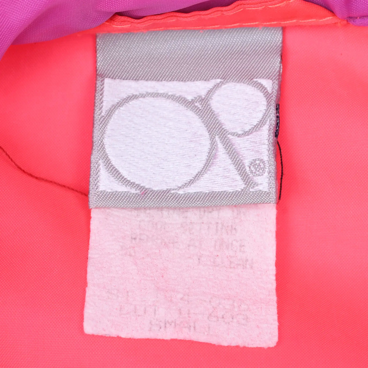 Close-up of Ocean Pacific neck label inside the pink pullover jacket
