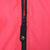 Close-up of black half zipper and Ocean Pacific logo pull on pink jacket