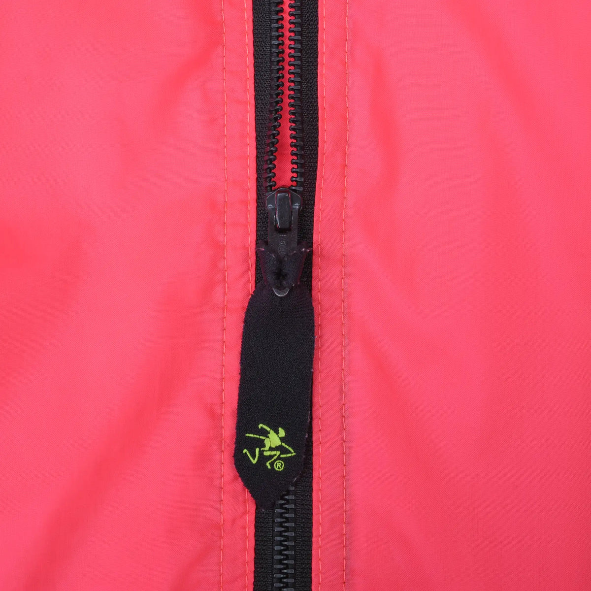 Close-up of black half zipper and Ocean Pacific logo pull on pink jacket