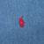 Close-up of red Ralph Lauren polo pony embroidery on blue denim fabric