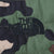 Close-up of black The North Face logo embroidery on green camouflage quilted fabric
