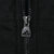Close-up of black front zipper with Adidas logo on the metal pull