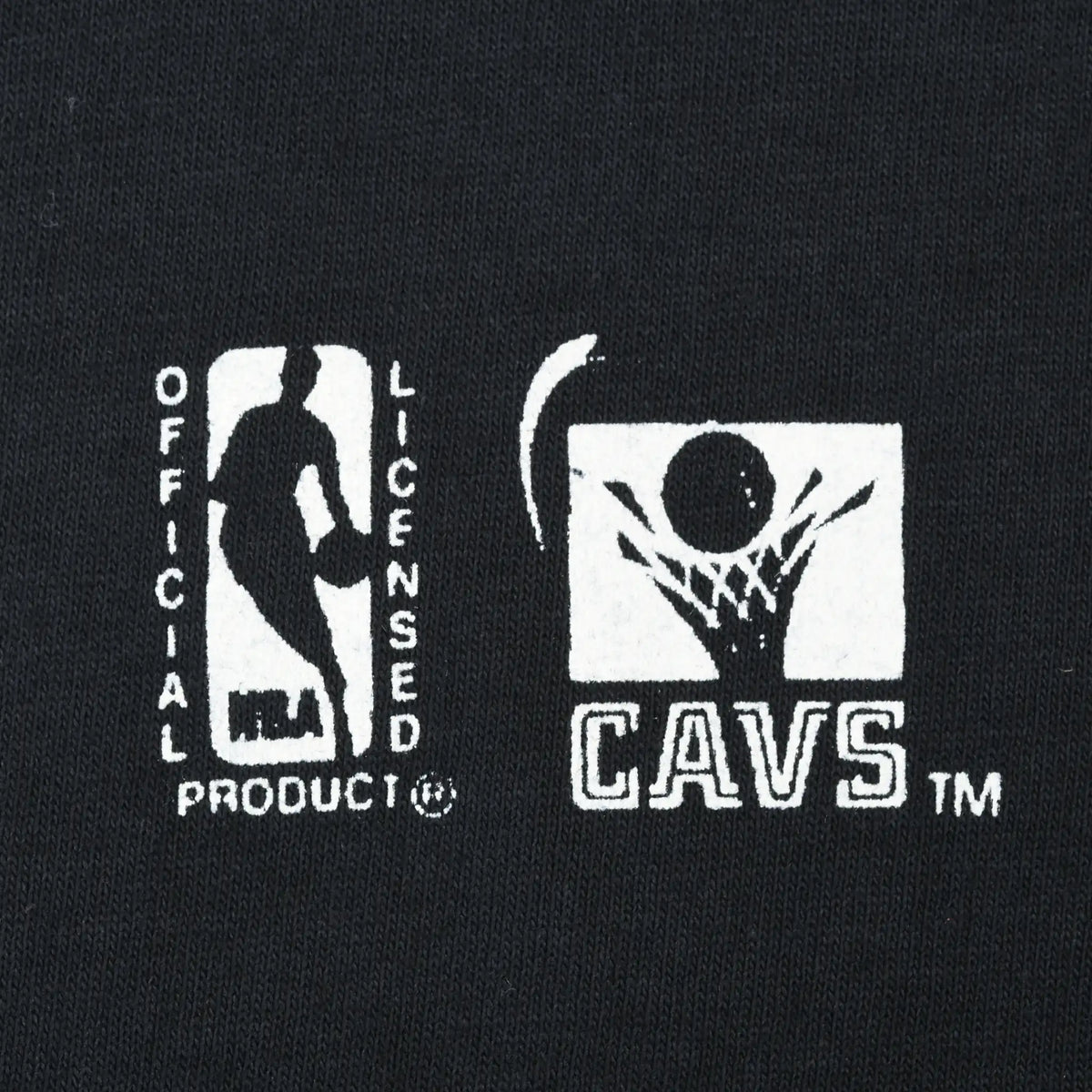 Close-up of NBA Official Licensed Product and Cavs logos printed on black fabric