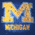 Close-up of maize block M and Michigan water-drop print on navy T-shirt
