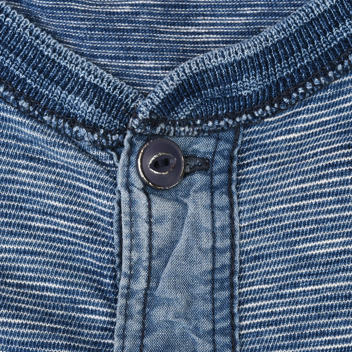 Close-up of ribbed henley collar and top button on blue striped Polo Ralph Lauren T-shirt