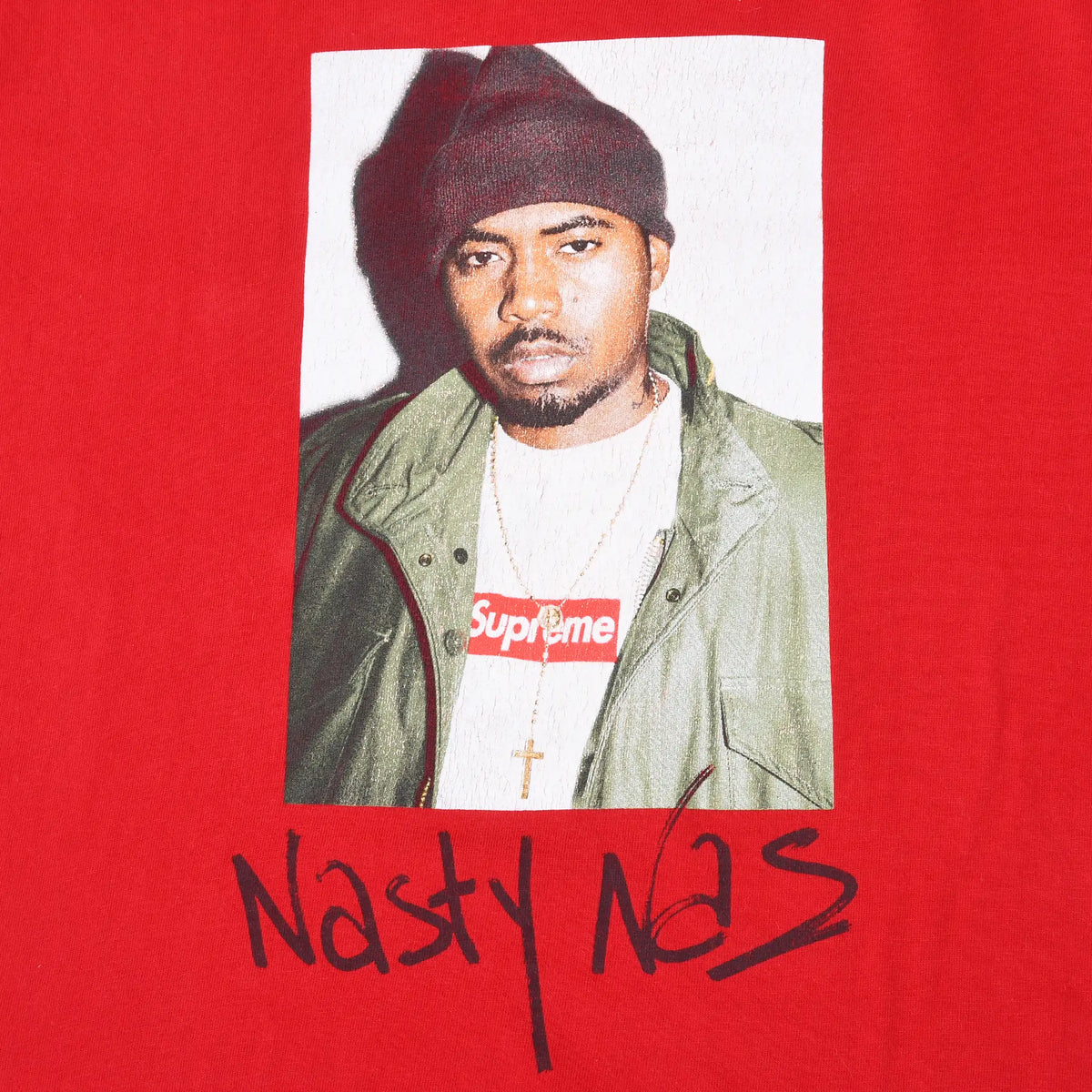 Close-up of Nas portrait and Nasty Nas signature print on red Supreme T-shirt