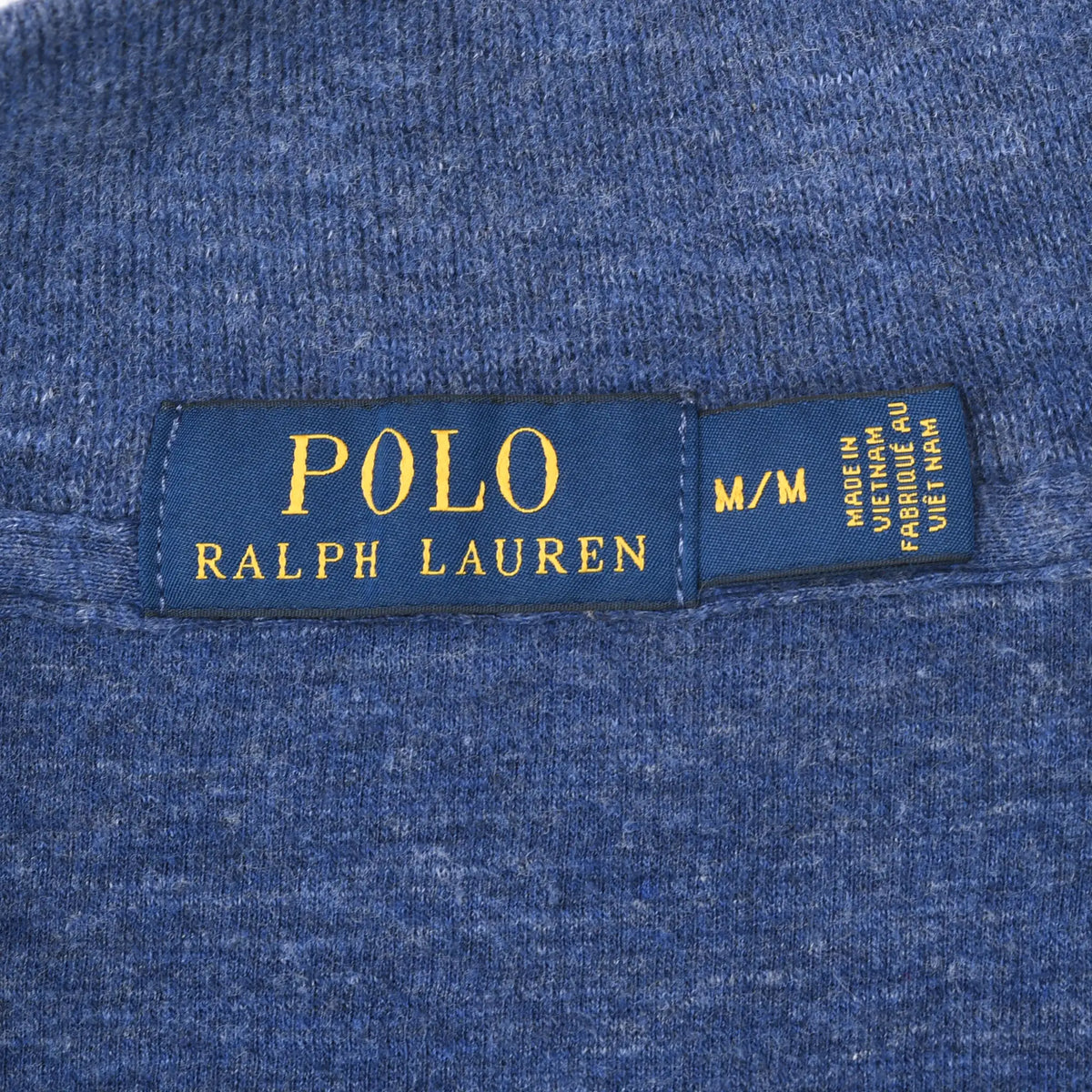 Polo Ralph Lauren neck label and M size tag on blue sweater