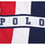 Close-up of navy POLO lettering across the white chest stripe and red, white and navy panels