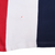 Close-up of lower red, white and navy panels with a faint spot marked on the white fabric